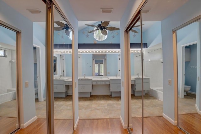 8521 Caitlin Ct, Hudson, FL 34667 - bathroom with toilet, tiled shower, vanity, ceiling fan, and wood finished floors