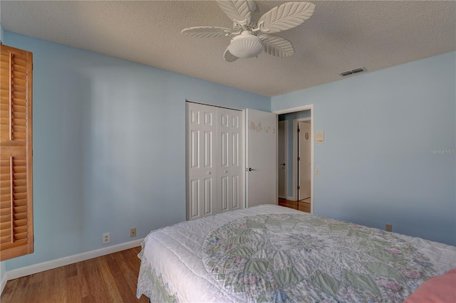 8521 Caitlin Ct, Hudson, FL 34667 - bedroom featuring wood finished floors, baseboards, a closet, a textured ceiling, and a ceiling fan