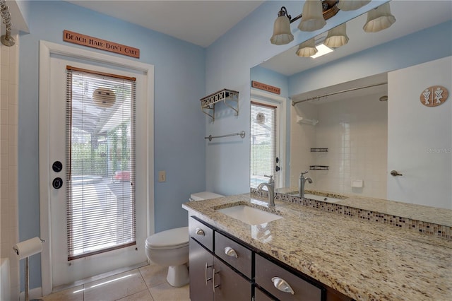 8521 Caitlin Ct, Hudson, FL 34667 - bathroom featuring toilet, vanity, tile patterned floors, and a shower
