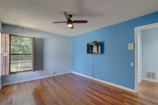 8521 Caitlin Ct, Hudson, FL 34667 - empty room with a textured ceiling, wood finished floors, ceiling fan, and baseboards