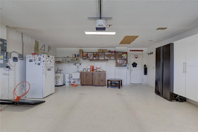 8521 Caitlin Ct, Hudson, FL 34667 - garage with freestanding refrigerator, electric water heater, and a garage door opener