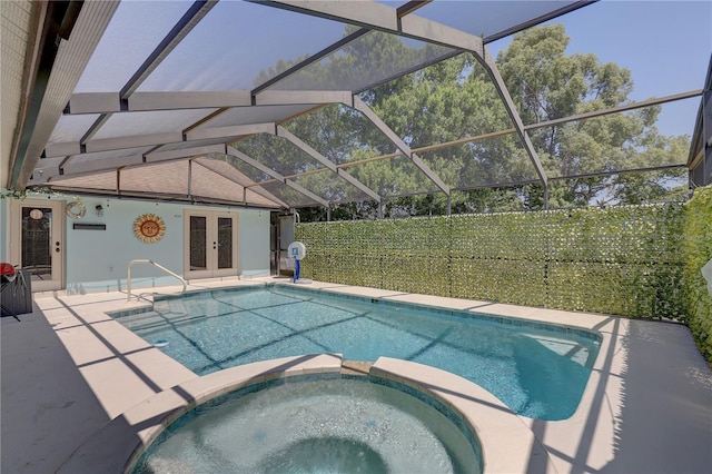 8521 Caitlin Ct, Hudson, FL 34667 - view of pool with french doors, a pool with connected hot tub, a patio, and a lanai