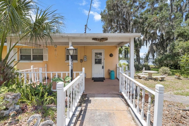 1226 S Telephone Point Rd, Inverness, FL 34450 - view of front of property with covered porch and stucco siding