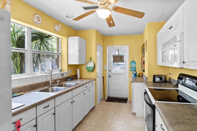 1226 S Telephone Point Rd, Inverness, FL 34450 - kitchen featuring white microwave, black / electric stove, a sink, white cabinetry, and a ceiling fan