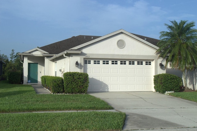 1922 Sassafras Dr, Wesley Chapel, FL 33543 - ranch-style house featuring an attached garage, stucco siding, driveway, and a front lawn