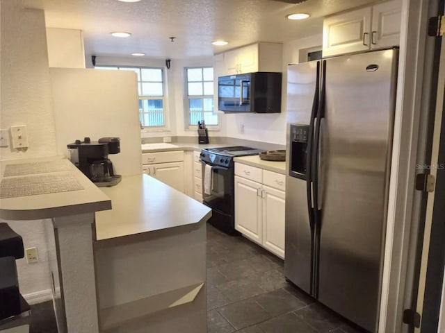 21103 Patio View Ct Unit 3302, Lutz, FL 33558 - kitchen with black appliances, a peninsula, white cabinets, light countertops, and recessed lighting