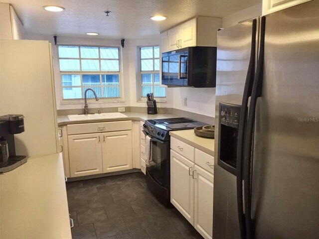21103 Patio View Ct Unit 3302, Lutz, FL 33558 - kitchen featuring black appliances, a sink, white cabinetry, light countertops, and recessed lighting