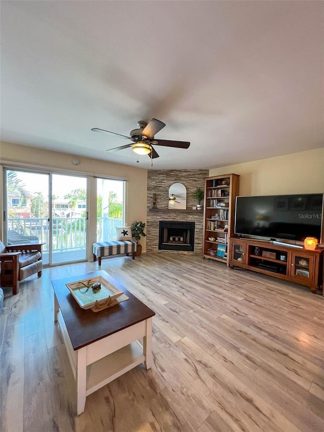 659 Garland Cir, Indian Rocks Beach, FL 33785 - living room with light wood-type flooring, a ceiling fan, and a large fireplace