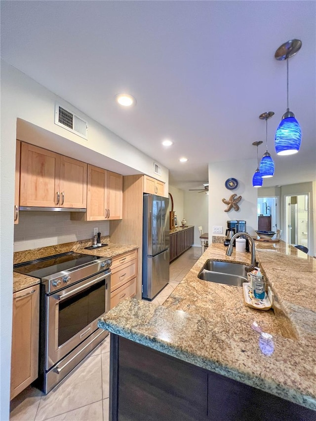659 Garland Cir, Indian Rocks Beach, FL 33785 - kitchen with appliances with stainless steel finishes, a sink, light brown cabinetry, light tile patterned floors, and light stone countertops