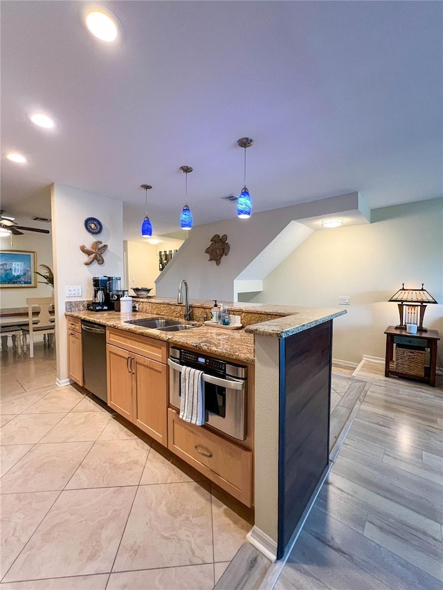 659 Garland Cir, Indian Rocks Beach, FL 33785 - kitchen with appliances with stainless steel finishes, a sink, pendant lighting, light stone countertops, and a peninsula