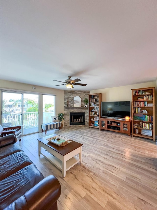 659 Garland Cir, Indian Rocks Beach, FL 33785 - living area with ceiling fan, light wood-style flooring, and a fireplace