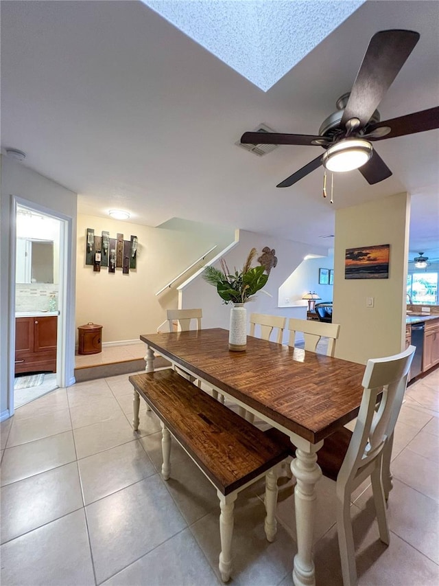 659 Garland Cir, Indian Rocks Beach, FL 33785 - dining space with a ceiling fan, light tile patterned floors, and a skylight