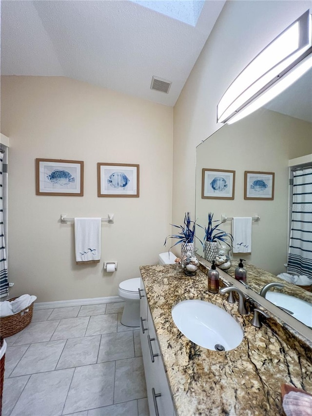 659 Garland Cir, Indian Rocks Beach, FL 33785 - full bathroom featuring toilet, lofted ceiling, vanity, a skylight, and baseboards