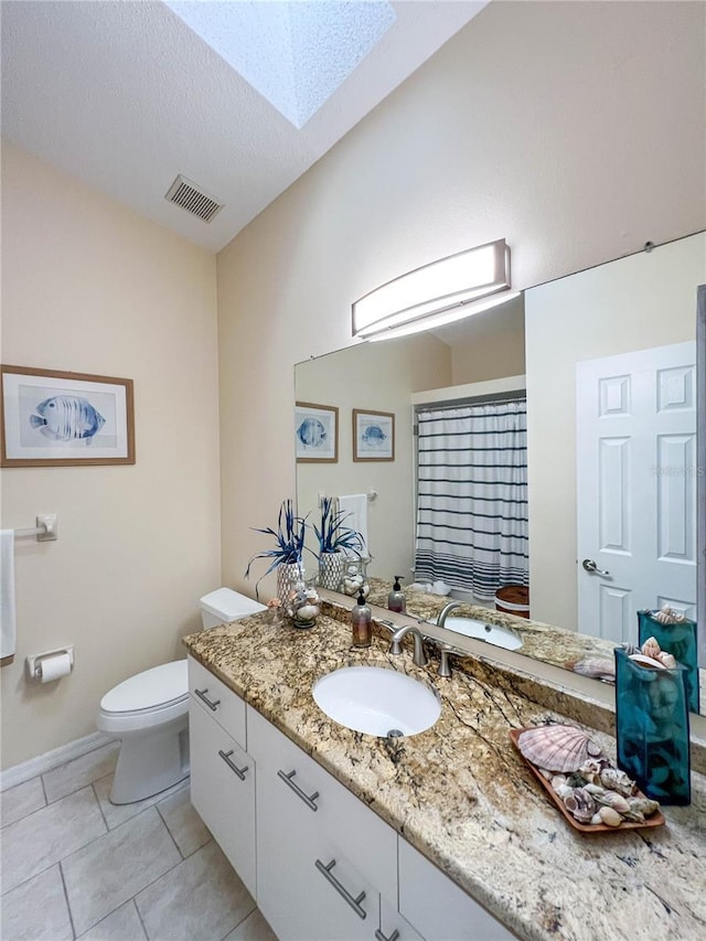 659 Garland Cir, Indian Rocks Beach, FL 33785 - full bath featuring toilet, vanity, a skylight, tile patterned floors, and a shower