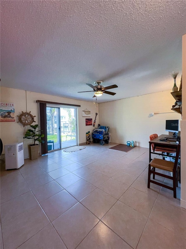 659 Garland Cir, Indian Rocks Beach, FL 33785 - living area with a textured ceiling, light tile patterned floors, and a ceiling fan