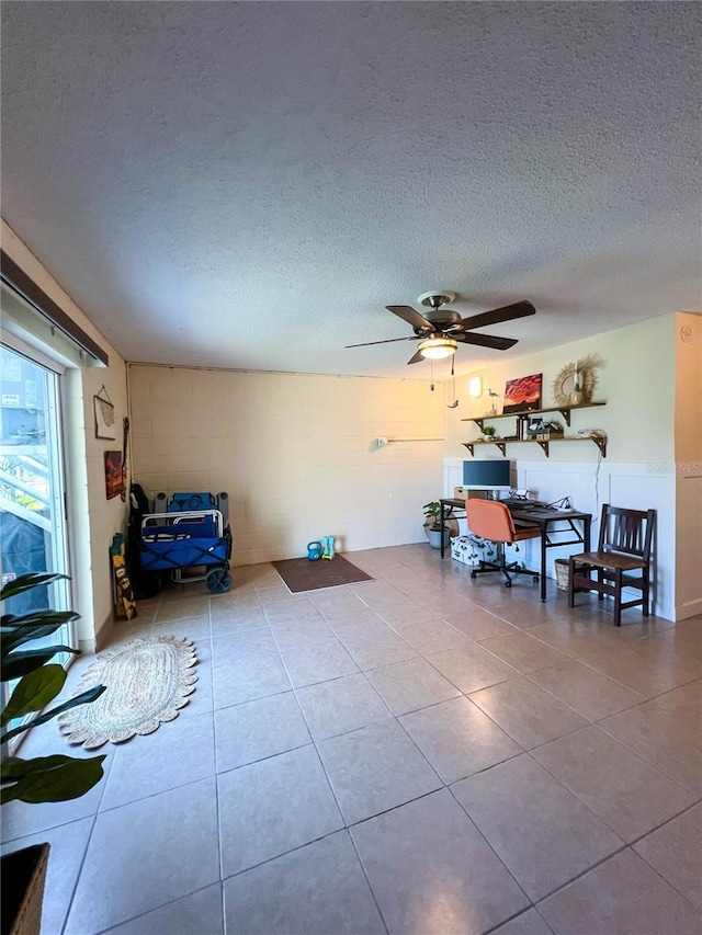 659 Garland Cir, Indian Rocks Beach, FL 33785 - tiled living area featuring a textured ceiling, ceiling fan, and an office area
