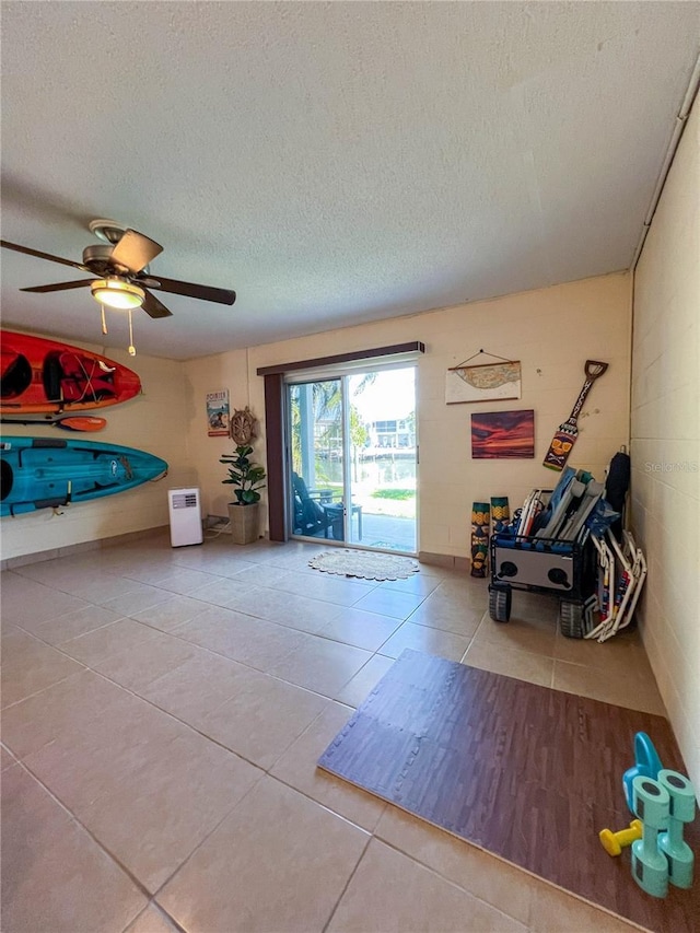 659 Garland Cir, Indian Rocks Beach, FL 33785 - rec room featuring tile patterned flooring, a textured ceiling, and a ceiling fan
