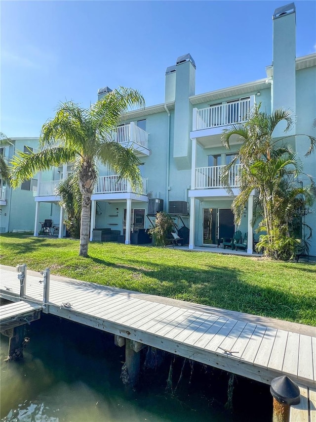 659 Garland Cir, Indian Rocks Beach, FL 33785 - back of house featuring a lawn and stucco siding