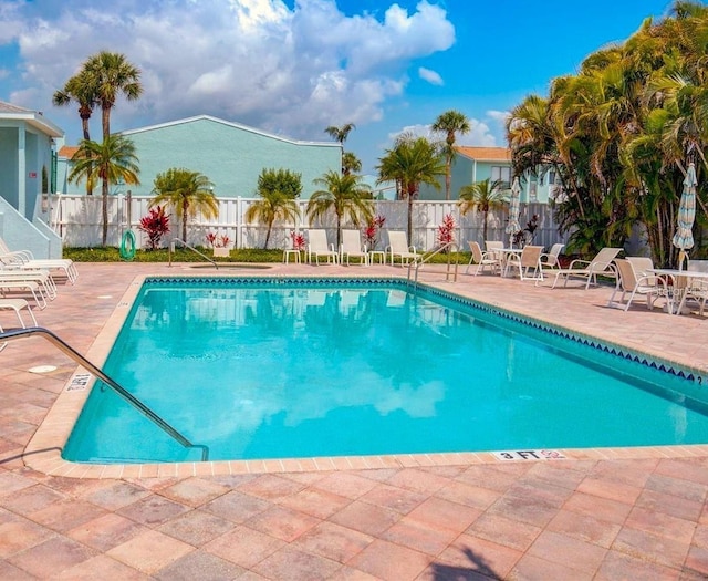 659 Garland Cir, Indian Rocks Beach, FL 33785 - community pool with a patio and a fenced backyard