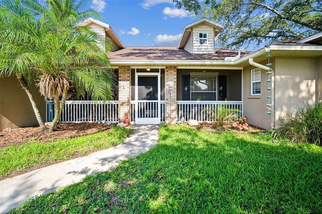 2507 Dewberry St, Valrico, FL 33596 - view of front of home featuring a porch, a front lawn, and stucco siding