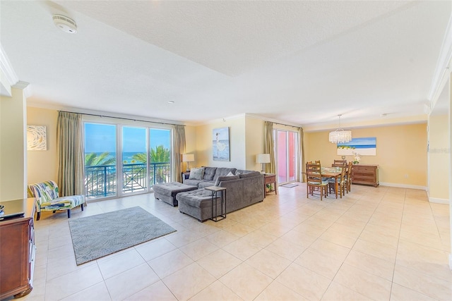 301 S Gulfview Blvd Unit 301, Clearwater Beach, FL 33767 - living room with crown molding, light tile patterned flooring, and a chandelier