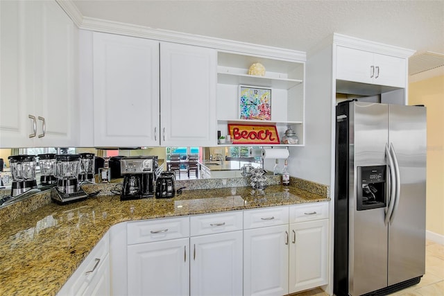301 S Gulfview Blvd Unit 301, Clearwater Beach, FL 33767 - kitchen with stainless steel fridge, open shelves, white cabinets, stone countertops, and light tile patterned floors