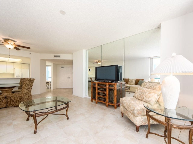 1520 Gulf Blvd Unit 1505, Clearwater Beach, FL 33767 - living area with a ceiling fan, healthy amount of natural light, and a textured ceiling