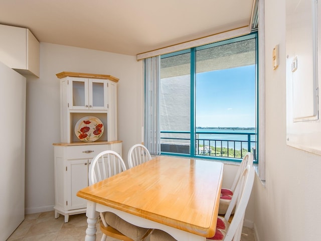 1520 Gulf Blvd Unit 1505, Clearwater Beach, FL 33767 - dining space with a water view, baseboards, and light tile patterned floors