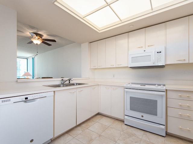 1520 Gulf Blvd Unit 1505, Clearwater Beach, FL 33767 - kitchen with white appliances, a sink, light countertops, and white cabinets