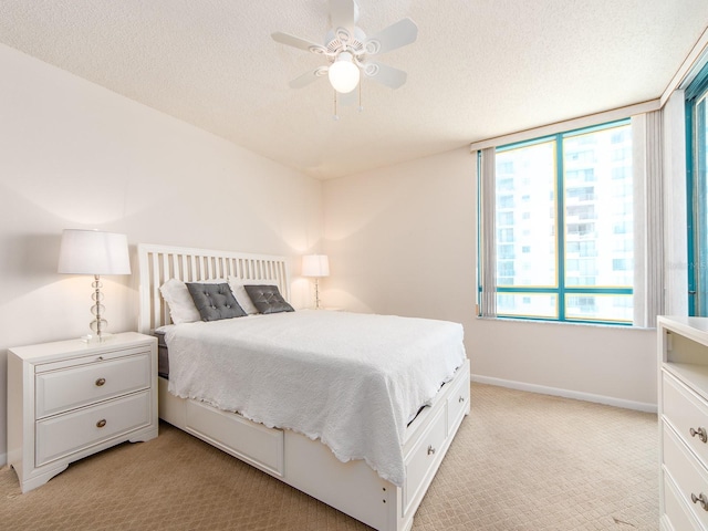 1520 Gulf Blvd Unit 1505, Clearwater Beach, FL 33767 - bedroom featuring light carpet, a textured ceiling, baseboards, and ceiling fan