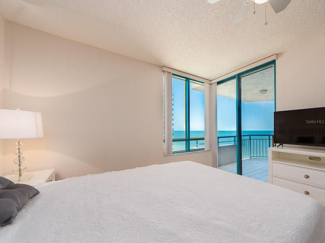 1520 Gulf Blvd Unit 1505, Clearwater Beach, FL 33767 - bedroom with access to outside, a textured ceiling, and ceiling fan