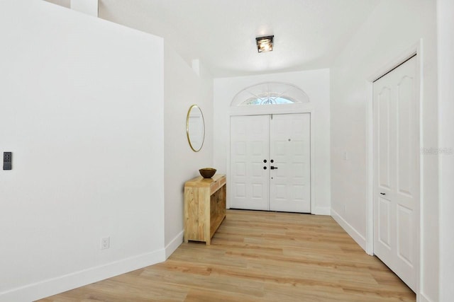 970 Ridgewood Ter, Tarpon Springs, FL 34689 - foyer entrance with baseboards and light wood finished floors