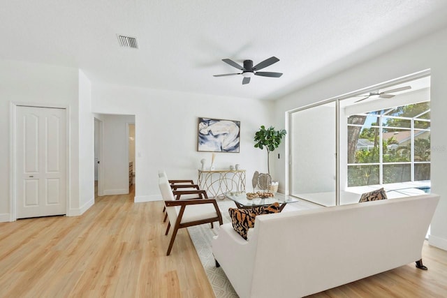 970 Ridgewood Ter, Tarpon Springs, FL 34689 - living area with a ceiling fan, light wood-style flooring, and baseboards
