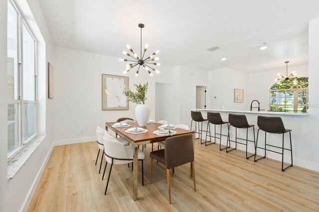 970 Ridgewood Ter, Tarpon Springs, FL 34689 - dining area with a chandelier, light wood finished floors, baseboards, and recessed lighting