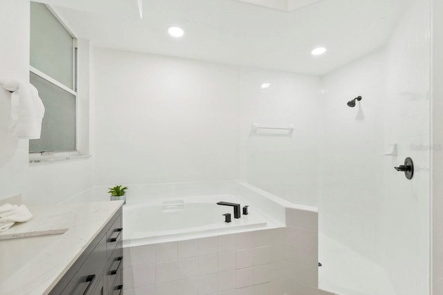 970 Ridgewood Ter, Tarpon Springs, FL 34689 - bathroom with vanity, a bath, a tile shower, and recessed lighting