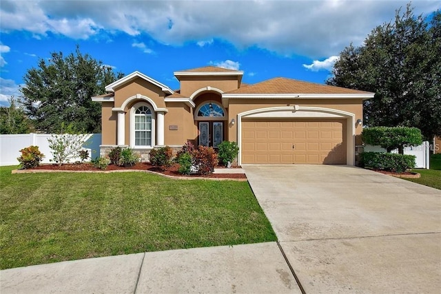 6519 Twin Bridges Dr, Zephyrhills, FL 33541 - mediterranean / spanish-style home featuring a garage, stucco siding, concrete driveway, and stone siding