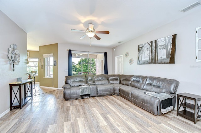 6519 Twin Bridges Dr, Zephyrhills, FL 33541 - living area with wood finished floors, ceiling fan, and baseboards