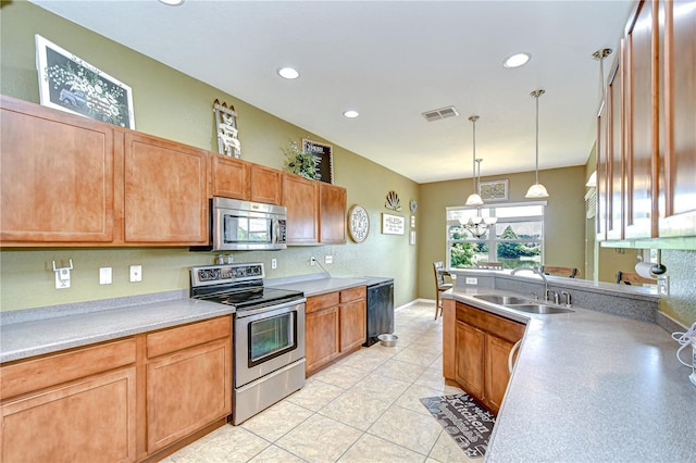 6519 Twin Bridges Dr, Zephyrhills, FL 33541 - kitchen featuring stainless steel appliances, a sink, recessed lighting, hanging light fixtures, and light countertops