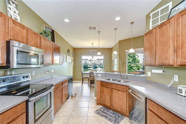 6519 Twin Bridges Dr, Zephyrhills, FL 33541 - kitchen featuring stainless steel appliances, a sink, a peninsula, plenty of natural light, and recessed lighting