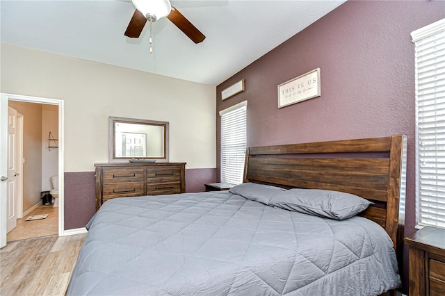 6519 Twin Bridges Dr, Zephyrhills, FL 33541 - bedroom with multiple windows, light wood finished floors, ensuite bath, and a ceiling fan