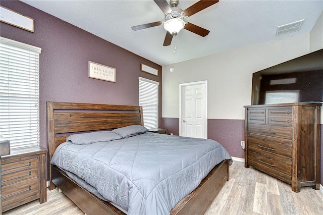 6519 Twin Bridges Dr, Zephyrhills, FL 33541 - bedroom with wood finished floors, a ceiling fan, and a textured wall