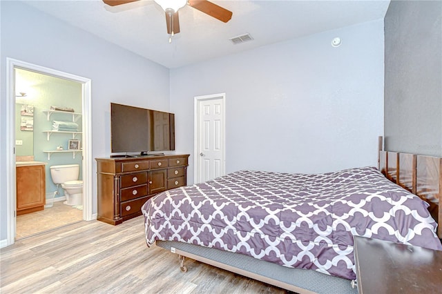 6519 Twin Bridges Dr, Zephyrhills, FL 33541 - bedroom with light wood-style floors, ensuite bath, and a ceiling fan