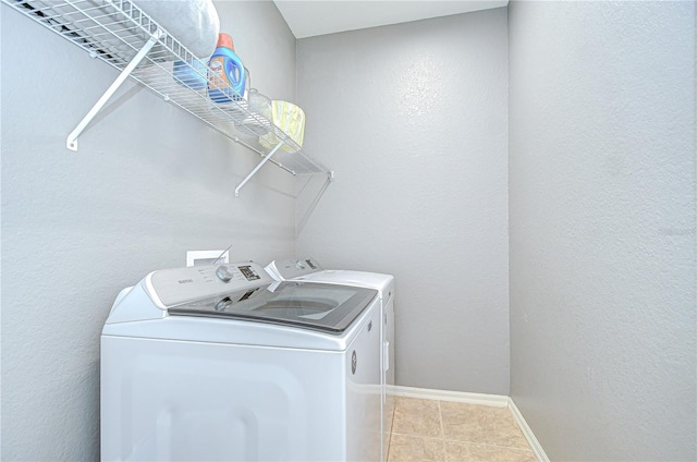 6519 Twin Bridges Dr, Zephyrhills, FL 33541 - washroom with washer and dryer, light tile patterned floors, and baseboards