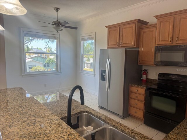 7330 New York Ave, Hudson, FL 34667 - kitchen with black appliances, brown cabinetry, light tile patterned flooring, a sink, and a ceiling fan