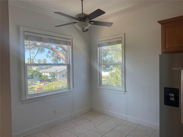 7330 New York Ave, Hudson, FL 34667 - unfurnished dining area featuring light tile patterned floors, plenty of natural light, ornamental molding, ceiling fan, and baseboards