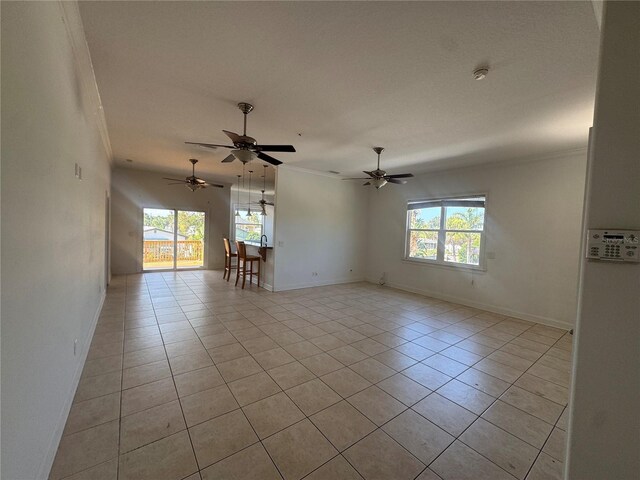 7330 New York Ave, Hudson, FL 34667 - unfurnished room featuring healthy amount of natural light, light tile patterned floors, baseboards, and crown molding