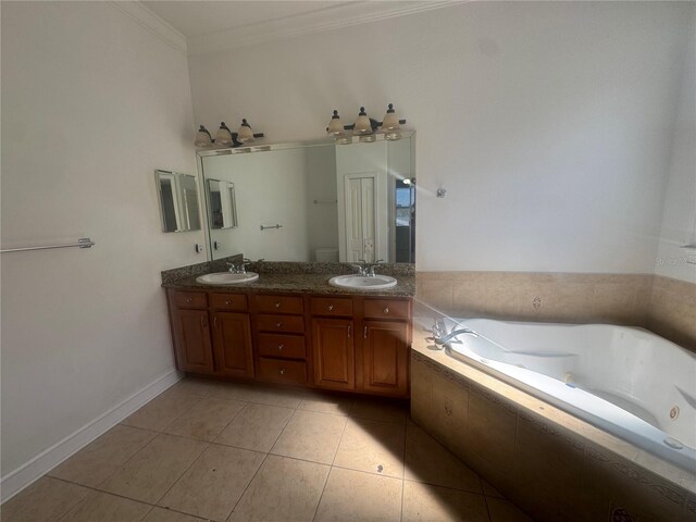 7330 New York Ave, Hudson, FL 34667 - bathroom featuring a whirlpool tub, double vanity, ornamental molding, tile patterned floors, and baseboards