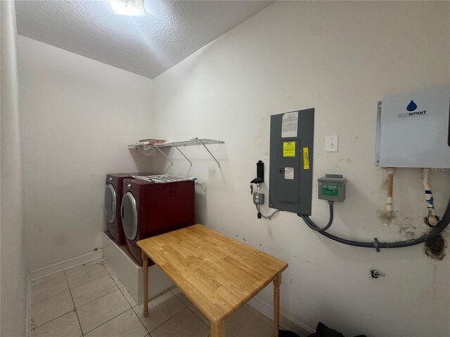 7330 New York Ave, Hudson, FL 34667 - laundry area with electric panel, light tile patterned flooring, washer / clothes dryer, a textured ceiling, and baseboards