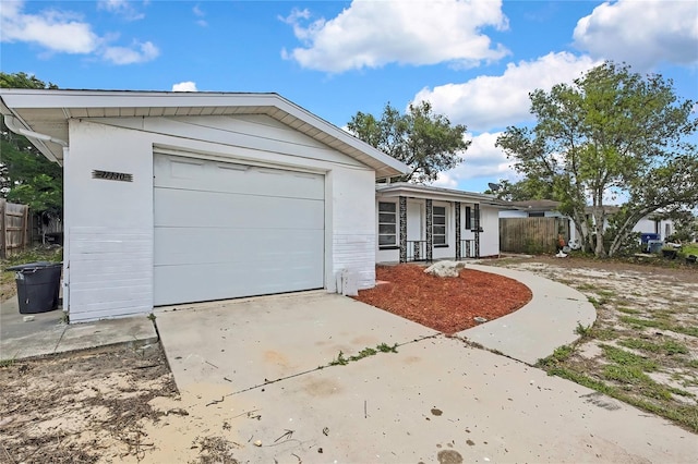 11130 White Oak Ln, Port Richey, FL 34668 - single story home with a porch, driveway, and a garage