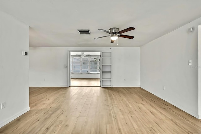 11130 White Oak Ln, Port Richey, FL 34668 - spare room with ceiling fan, wood finished floors, and baseboards